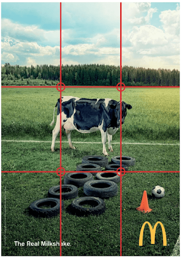 McDonalds ad with a cow in a field